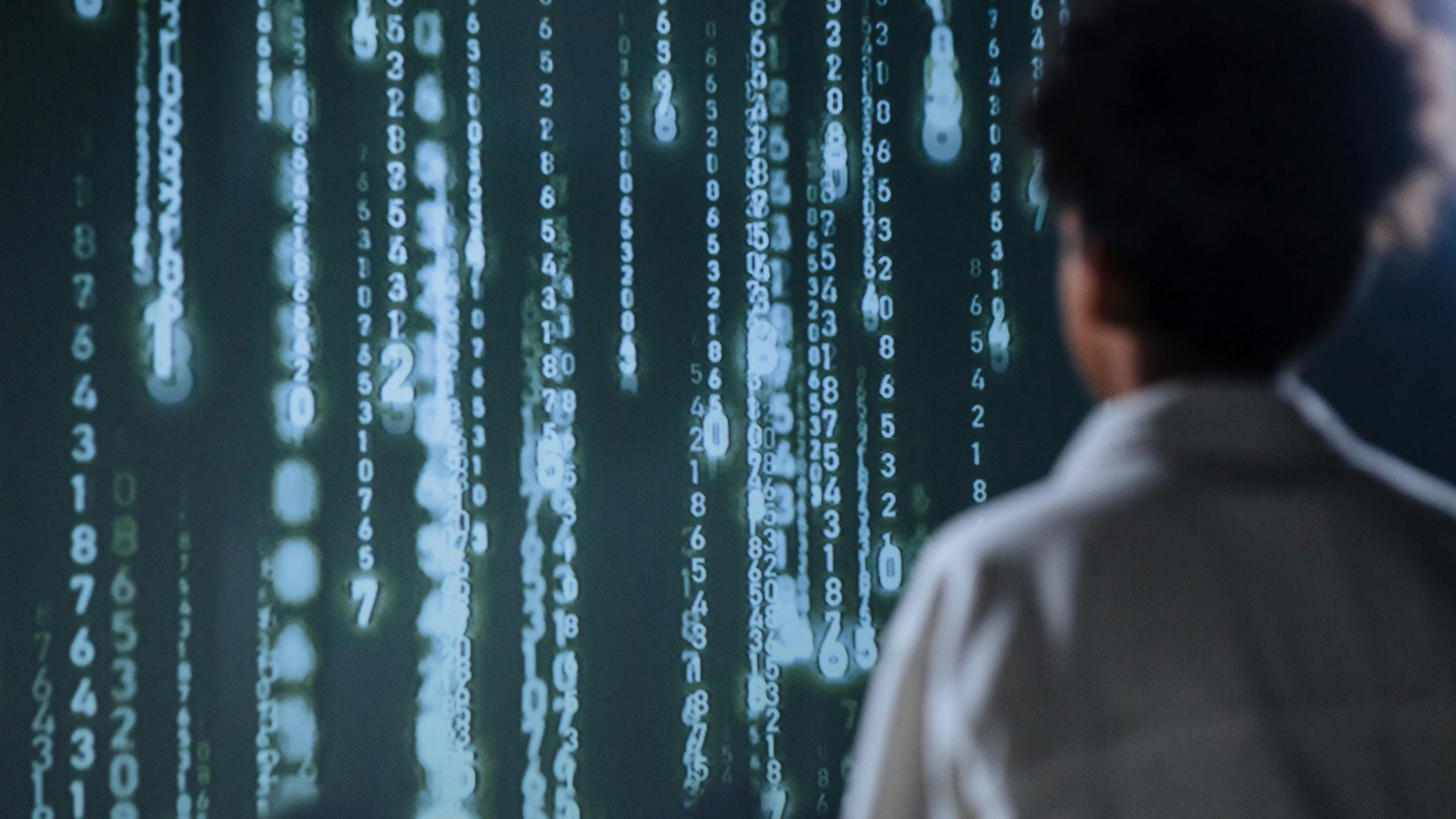 Bioinformatician looking at a screen with numbers